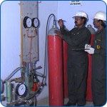 Technicians servicing marine safety cylinders