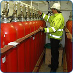 Technician inspecting fire safety cylinders